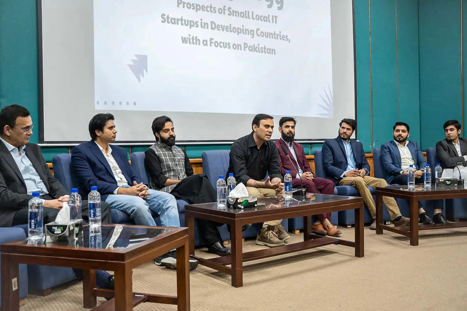 Funavry team members on a panel on stage, in front of a screen about the prospects of local IT startups in Pakistan